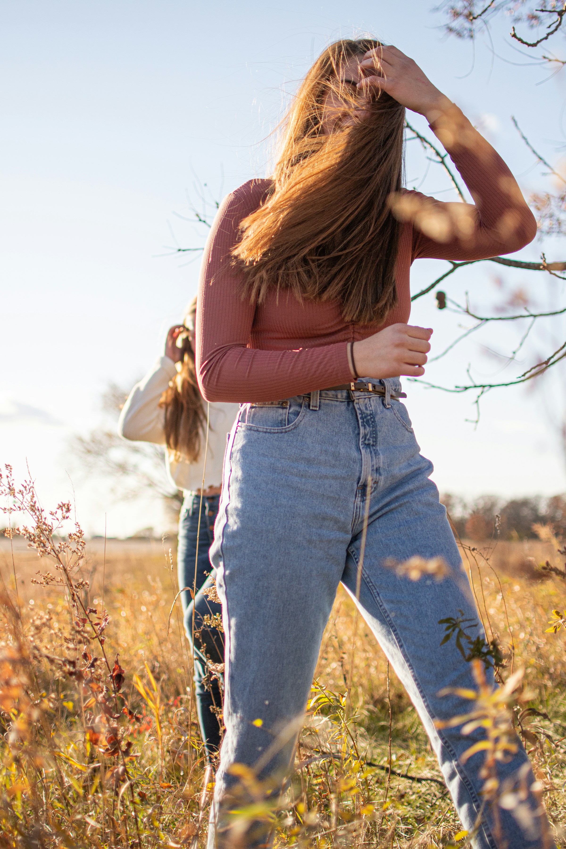 A woman standing in golden hour light, windswept and confident — the version of herself she's working toward.